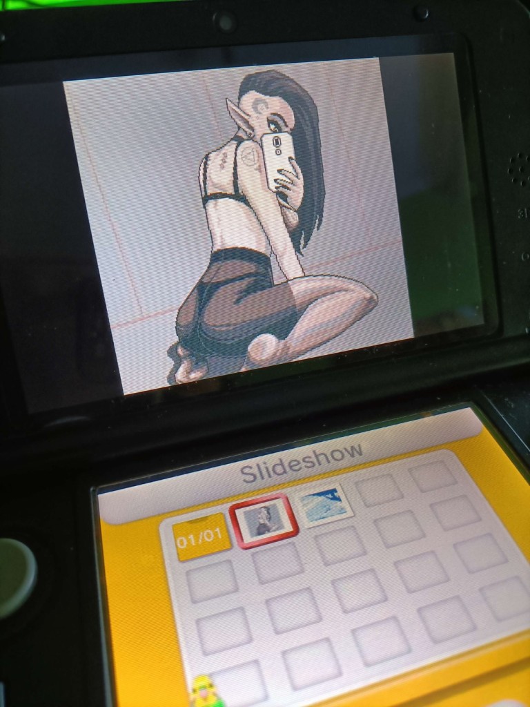 A photo of a Nintendo 3DS displaying a pixel art illustration imported to it's gallery and that can now be viewed in 3D.